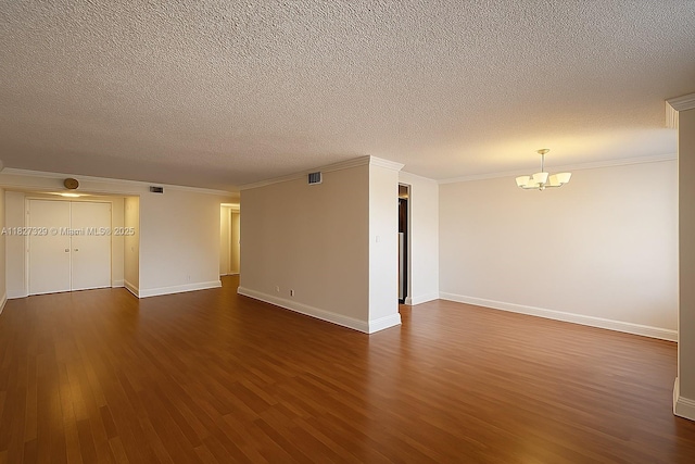 251 174th St Unit 115, Sunny Isles Beach, FL 33160 - spare room featuring a chandelier, dark wood-style flooring, a textured ceiling, and ornamental molding