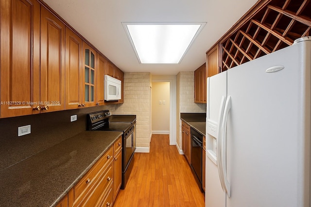 251 174th St Unit 115, Sunny Isles Beach, FL 33160 - kitchen featuring black appliances, brown cabinets, decorative backsplash, glass insert cabinets, and light wood finished floors