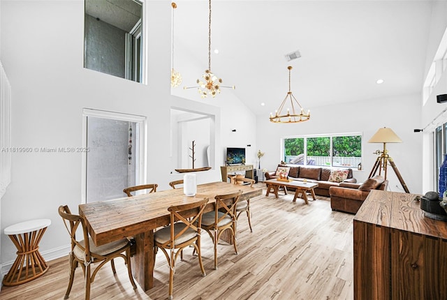 1151 W Lake St, Hollywood, FL 33019 - dining space with a chandelier, high vaulted ceiling, light wood finished floors, and recessed lighting