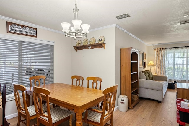 1360 S Audubon Dr, Homestead, FL 33035 - dining area with light wood-type flooring, a chandelier, crown molding, and a textured ceiling