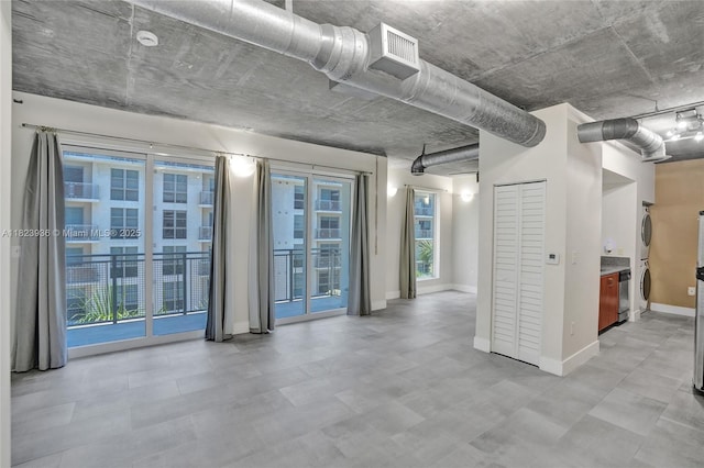 455 NE 25th St Unit 609, Miami, FL 33137 - below grade area featuring stacked washer / dryer and tile patterned floors