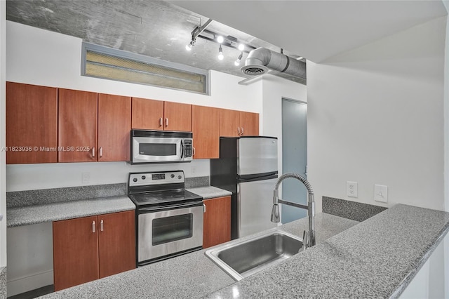 455 NE 25th St Unit 609, Miami, FL 33137 - kitchen with stainless steel appliances and brown cabinets