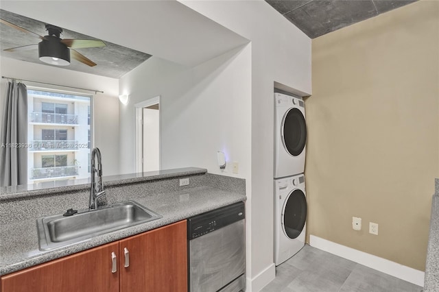 455 NE 25th St Unit 609, Miami, FL 33137 - kitchen with stainless steel dishwasher, stacked washer and clothes dryer, brown cabinets, and ceiling fan