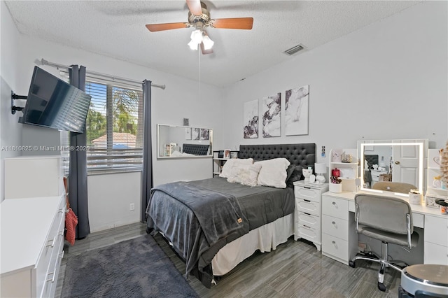 6421 Lake Tern Ln, Coconut Creek, FL 33073 - bedroom featuring dark wood-style floors, a textured ceiling, a desk, and a ceiling fan