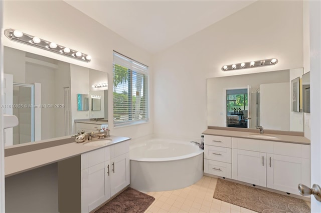 6421 Lake Tern Ln, Coconut Creek, FL 33073 - full bathroom with healthy amount of natural light, a stall shower, a bath, two vanities, and vaulted ceiling