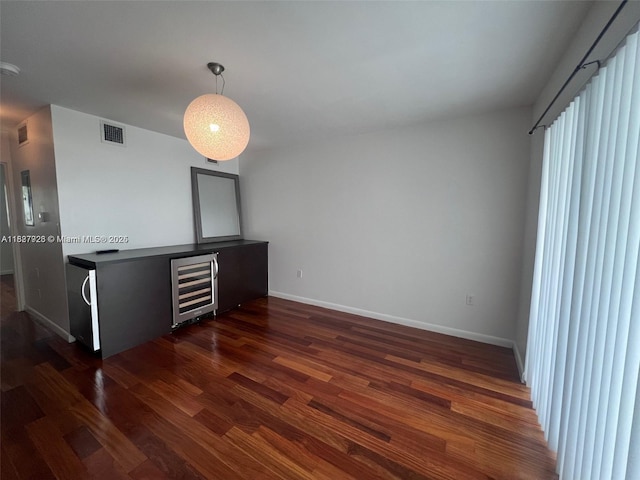 1550 Pennsylvania Ave Unit 126, Miami Beach, FL 33139 - unfurnished living room with wine cooler and dark wood-type flooring