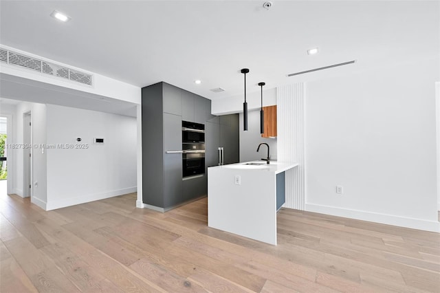 200 Sunrise Dr Unit 200C, Key Biscayne, FL 33149 - kitchen featuring stainless steel double oven, light wood-style floors, modern cabinets, light countertops, and recessed lighting