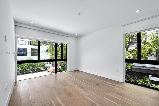 200 Sunrise Dr Unit 200C, Key Biscayne, FL 33149 - spare room featuring plenty of natural light and hardwood / wood-style flooring
