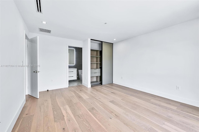 200 Sunrise Dr Unit 200C, Key Biscayne, FL 33149 - unfurnished bedroom with light wood finished floors, ensuite bathroom, and recessed lighting