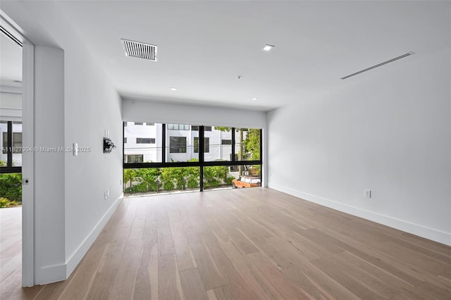 200 Sunrise Dr Unit 200C, Key Biscayne, FL 33149 - spare room featuring wood finished floors, a pendent fire sprinkler, and recessed lighting