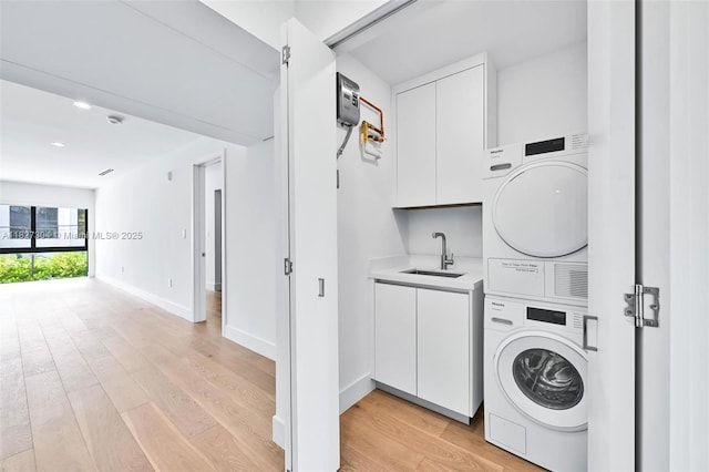 200 Sunrise Dr Unit 200C, Key Biscayne, FL 33149 - washroom with stacked washer / dryer, cabinet space, light wood-style flooring, and recessed lighting