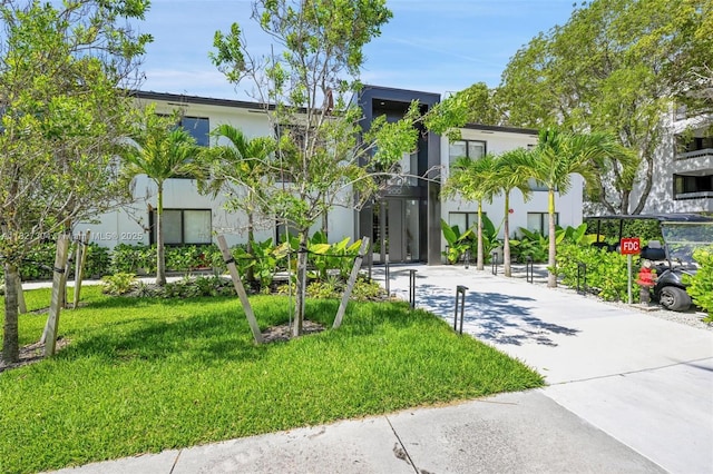 200 Sunrise Dr Unit 200C, Key Biscayne, FL 33149 - view of front of home with a front yard and stucco siding