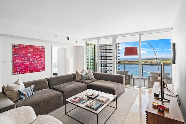 450 Alton Rd Unit 2705, Miami Beach, FL 33139 - living room with floor to ceiling windows, light tile patterned flooring, and a water view
