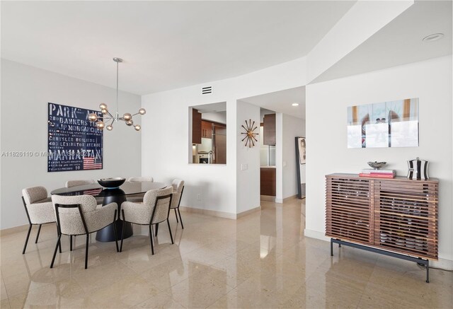 450 Alton Rd Unit 2705, Miami Beach, FL 33139 - dining room featuring a chandelier, granite tiled floors, and recessed lighting