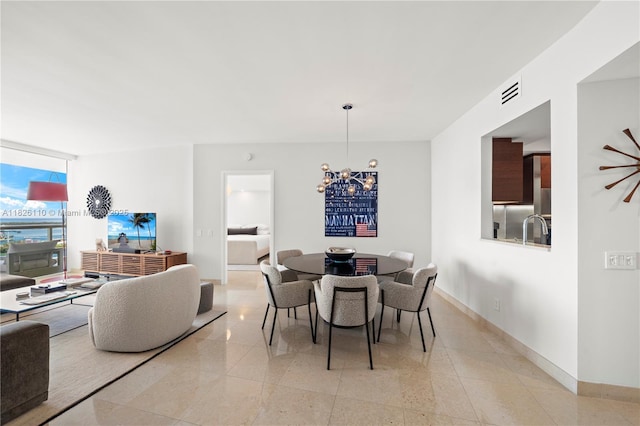 450 Alton Rd Unit 2705, Miami Beach, FL 33139 - dining room featuring a chandelier and light tile patterned floors