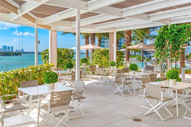 450 Alton Rd Unit 2705, Miami Beach, FL 33139 - view of patio / terrace with outdoor dining space, a pergola, and a water view