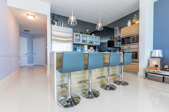 2020 N Bayshore Dr Unit 2005, Miami, FL 33137 - kitchen featuring built in appliances, wall chimney range hood, and tile patterned floors