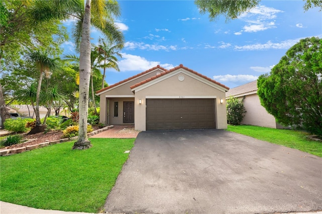 4361 Mahogany Ridge Dr, Weston, FL 33331 - view of front of house with stucco siding, asphalt driveway, an attached garage, a front lawn, and a tiled roof