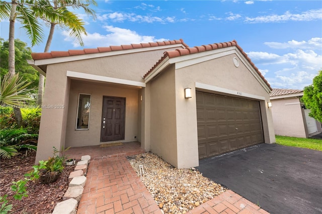 4361 Mahogany Ridge Dr, Weston, FL 33331 - view of front of house featuring stucco siding, a garage, driveway, and a tiled roof
