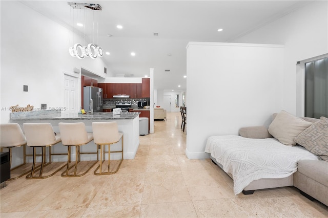 4361 Mahogany Ridge Dr, Weston, FL 33331 - kitchen with open floor plan, stainless steel appliances, a peninsula, a kitchen bar, and recessed lighting