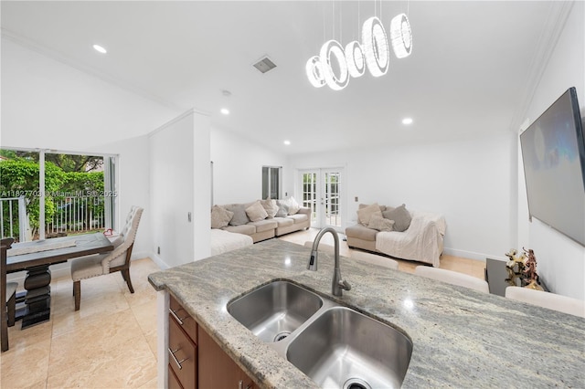 4361 Mahogany Ridge Dr, Weston, FL 33331 - kitchen with healthy amount of natural light, lofted ceiling, pendant lighting, french doors, and brown cabinetry