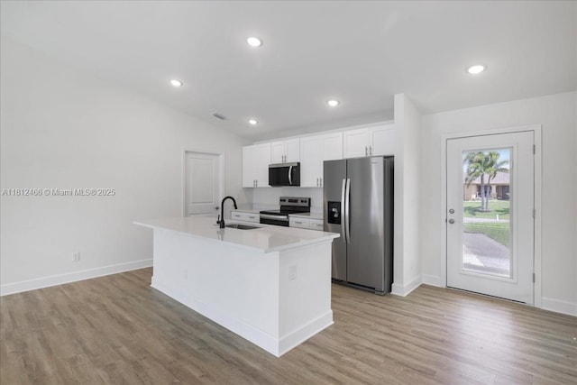 1119 NW 19th St, Cape Coral, FL 33993 - kitchen with stainless steel appliances, white cabinets, light wood-style flooring, light countertops, and recessed lighting