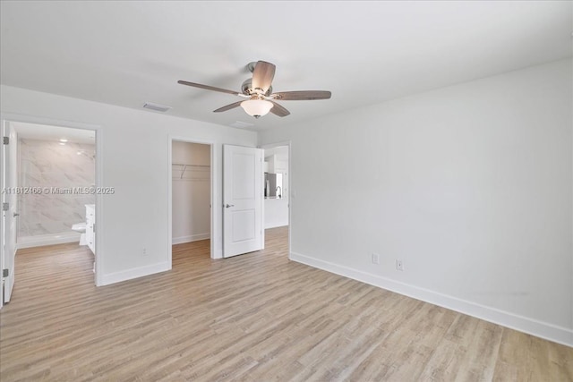 1119 NW 19th St, Cape Coral, FL 33993 - unfurnished bedroom with light wood-type flooring, a closet, a walk in closet, and ensuite bathroom