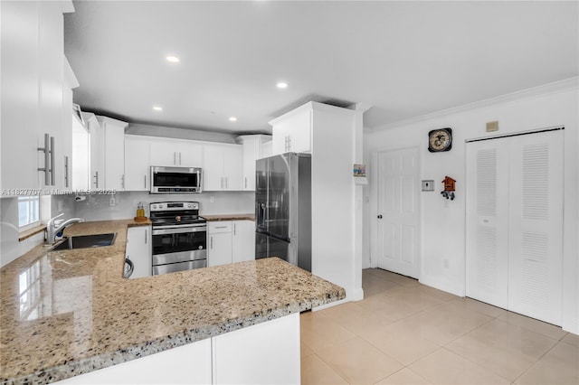 2260 SW 84th Way, Miramar, FL 33025 - kitchen with stainless steel appliances, ornamental molding, recessed lighting, light stone countertops, and a peninsula