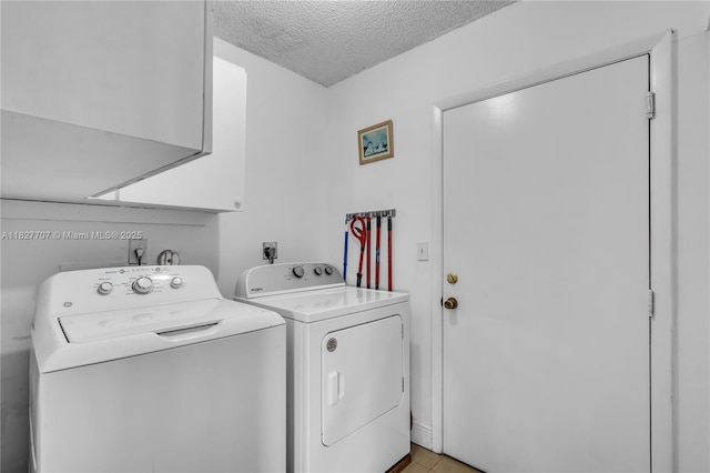 2260 SW 84th Way, Miramar, FL 33025 - washroom featuring washing machine and clothes dryer, cabinet space, a textured ceiling, and light tile patterned floors