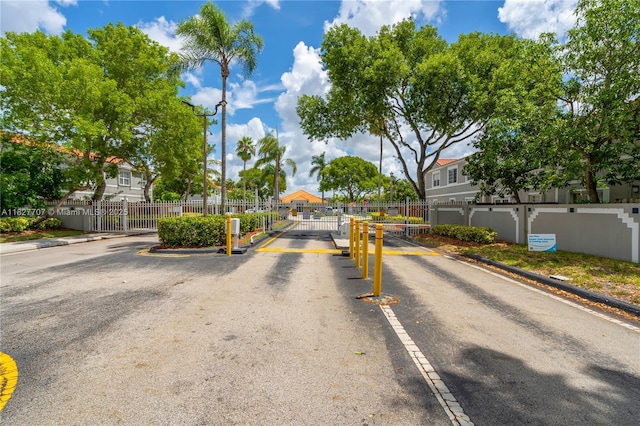 2260 SW 84th Way, Miramar, FL 33025 - view of asphalt road featuring a gate, curbs, a gated entry, and a residential view