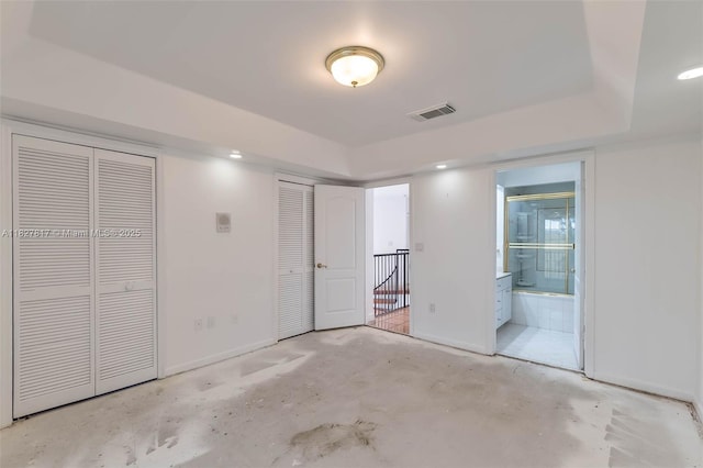 3136 Virginia St, Miami, FL 33133 - unfurnished bedroom featuring two closets, unfinished concrete floors, and ensuite bath