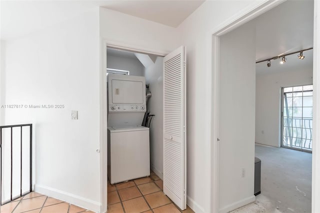 3136 Virginia St, Miami, FL 33133 - laundry room with stacked washer / drying machine and rail lighting