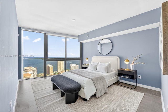 495 Brickell Ave Unit 3901, Miami, FL 33131 - bedroom with multiple windows, a wall of windows, and a water view