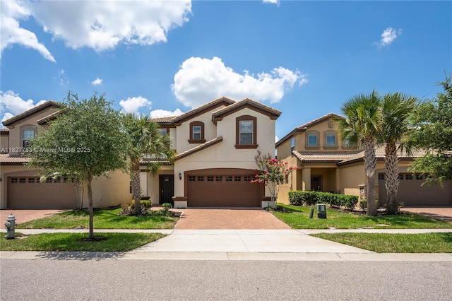 1892 Gobi Dr, Kissimmee, FL 3474 - mediterranean / spanish-style home featuring a tiled roof, stucco siding, and a garage