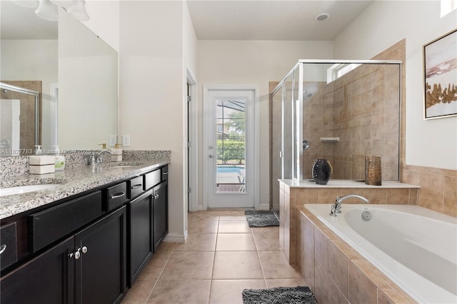 1892 Gobi Dr, Kissimmee, FL 3474 - full bathroom with a stall shower, a bath, double vanity, and tile patterned floors