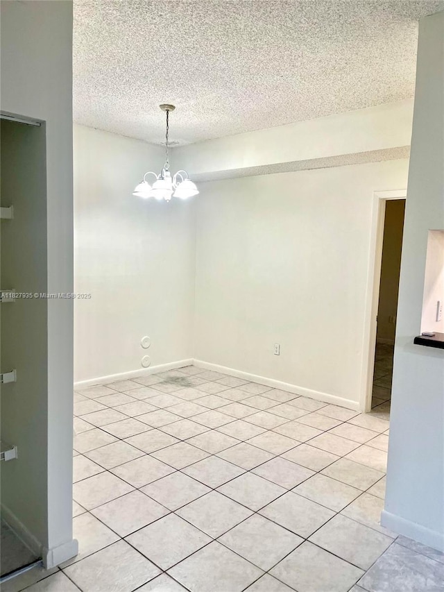 2331 NW 96th Ter Unit 17F, Pembroke Pines, FL 33024 - spare room featuring light tile patterned floors, a chandelier, and a textured ceiling
