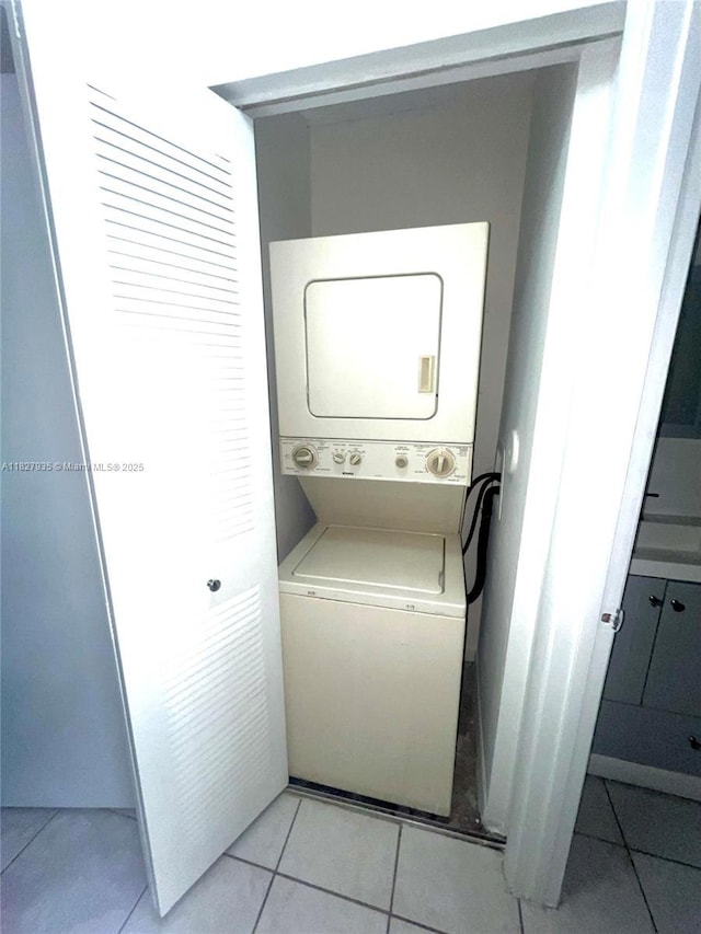 2331 NW 96th Ter Unit 17F, Pembroke Pines, FL 33024 - washroom featuring stacked washing machine and dryer and light tile patterned flooring
