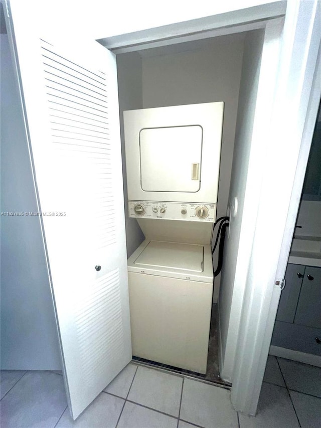 2331 NW 96th Ter Unit 17F, Pembroke Pines, FL 33024 - washroom featuring estacked washer and dryer and light tile patterned flooring