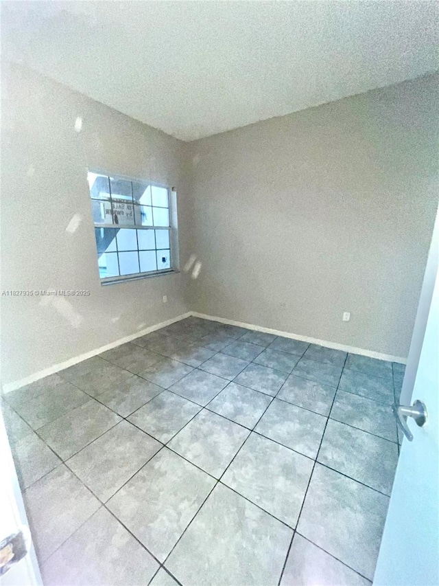 2331 NW 96th Ter Unit 17F, Pembroke Pines, FL 33024 - empty room with tile patterned floors and baseboards