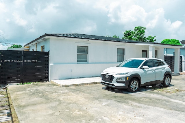 90 E 41st St, Hialeah, FL 33013 - view of side of home with a metal roof and a standing seam roof