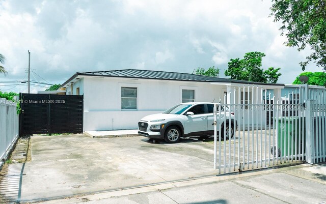 90 E 41st St, Hialeah, FL 33013 - view of front of property featuring a metal roof, a standing seam roof, and stucco siding