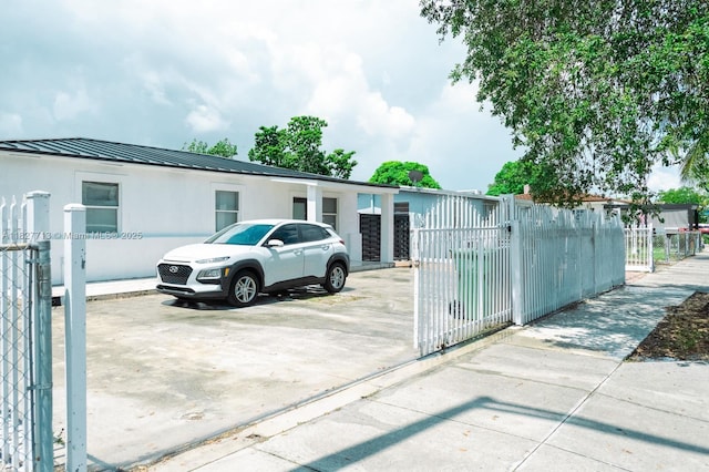 90 E 41st St, Hialeah, FL 33013 - view of vehicle parking with a fenced front yard and a gate