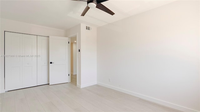 933 NE 24th Ave Unit 169, Hallandale Beach, FL 33009 - unfurnished bedroom featuring light wood-style flooring, a closet, and ceiling fan