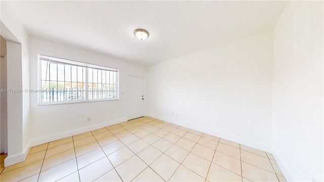 1190 NW 65th St, Miami, FL 33150 - unfurnished room with baseboards and light tile patterned flooring