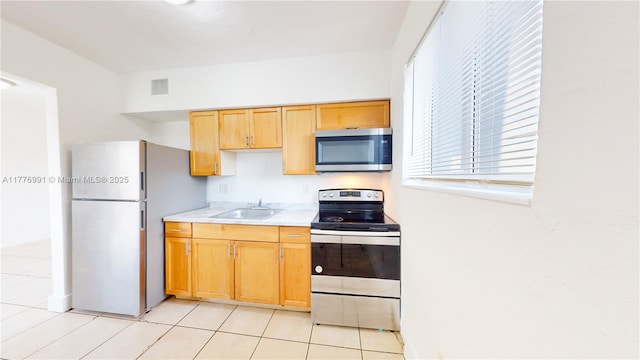 1190 NW 65th St, Miami, FL 33150 - kitchen with stainless steel appliances, light countertops, and light tile patterned floors