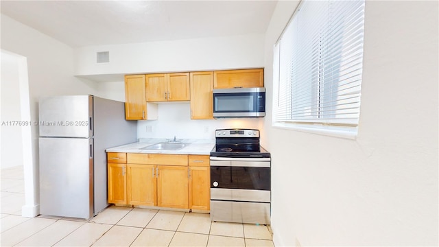 1190 NW 65th St, Miami, FL 33150 - kitchen featuring stainless steel appliances, light countertops, and light tile patterned flooring