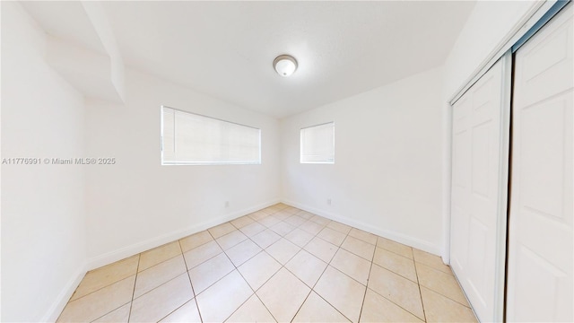 1190 NW 65th St, Miami, FL 33150 - unfurnished bedroom with a closet and light tile patterned flooring