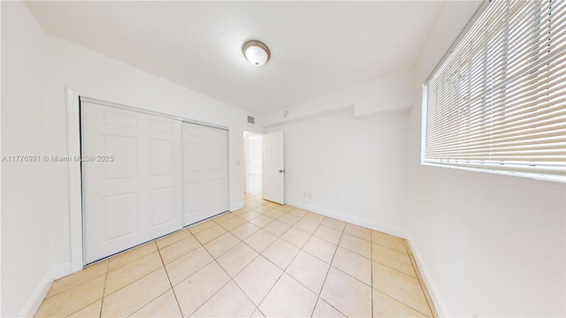 1190 NW 65th St, Miami, FL 33150 - unfurnished bedroom featuring light tile patterned floors and a closet