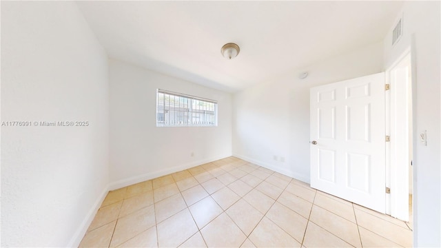 1190 NW 65th St, Miami, FL 33150 - unfurnished bedroom with baseboards and light tile patterned flooring