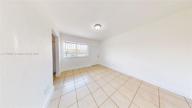 1190 NW 65th St, Miami, FL 33150 - empty room with baseboards and light tile patterned flooring